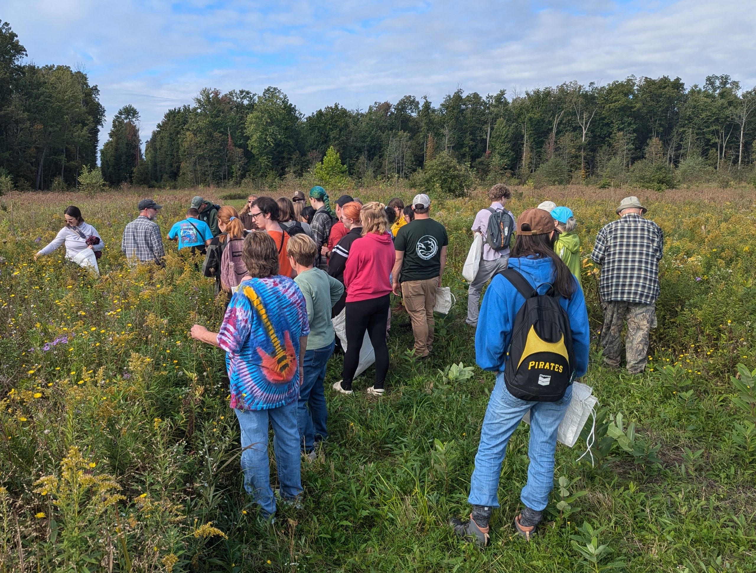 A volunteer points at a trail map.