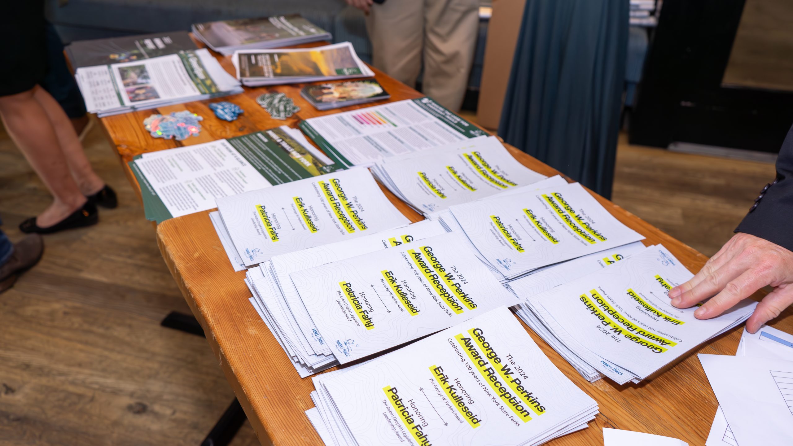 A stack of programs on a table at the George W. Perkins Award Reception.