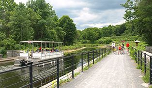 A cyclist rides past a handmade sign with a heart and the word cyclists.