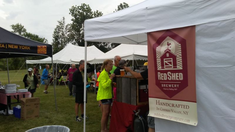 A cyclist rides past a handmade sign with a heart and the word cyclists.
