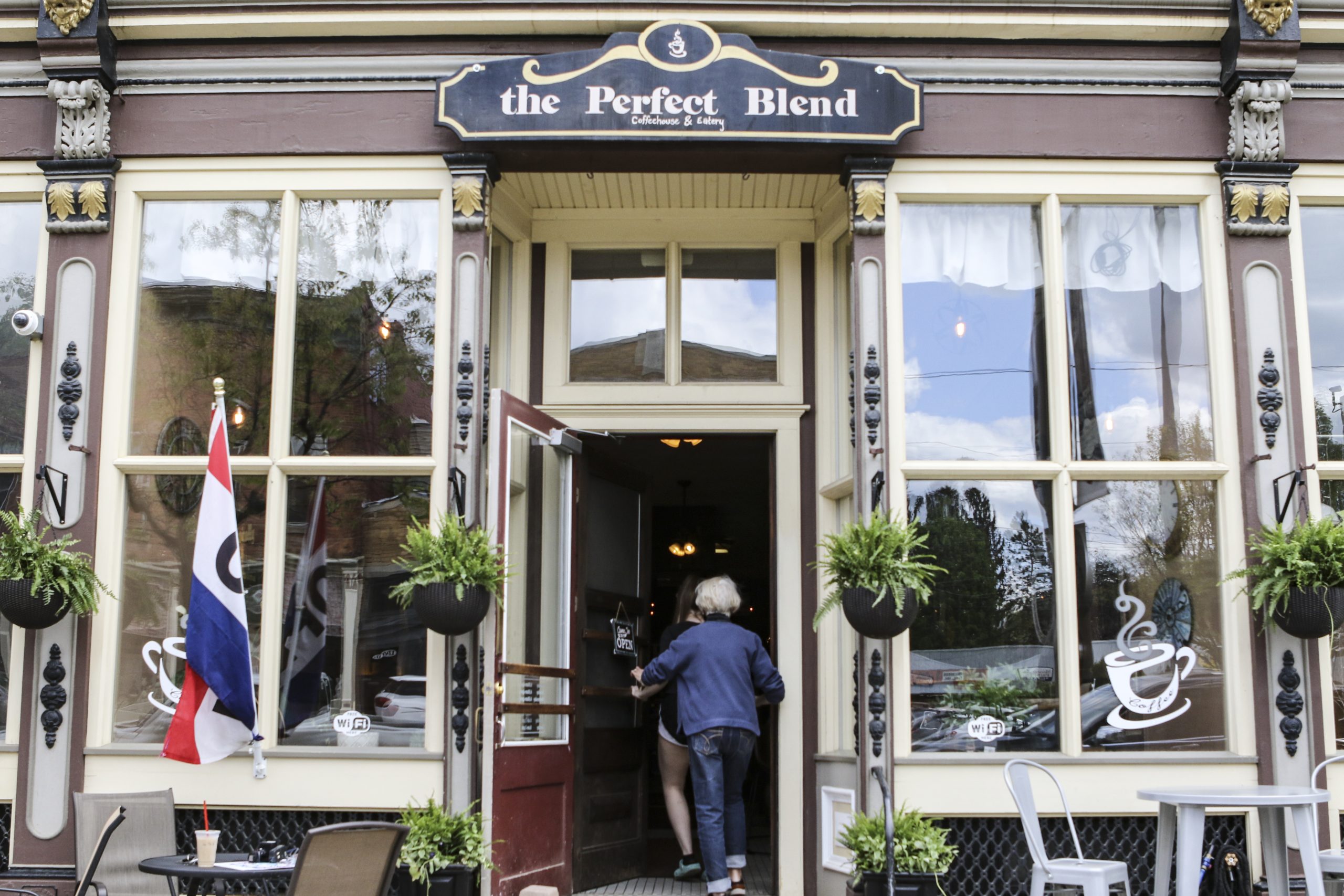 Woman walking into a coffee shop in Cuba, New York
