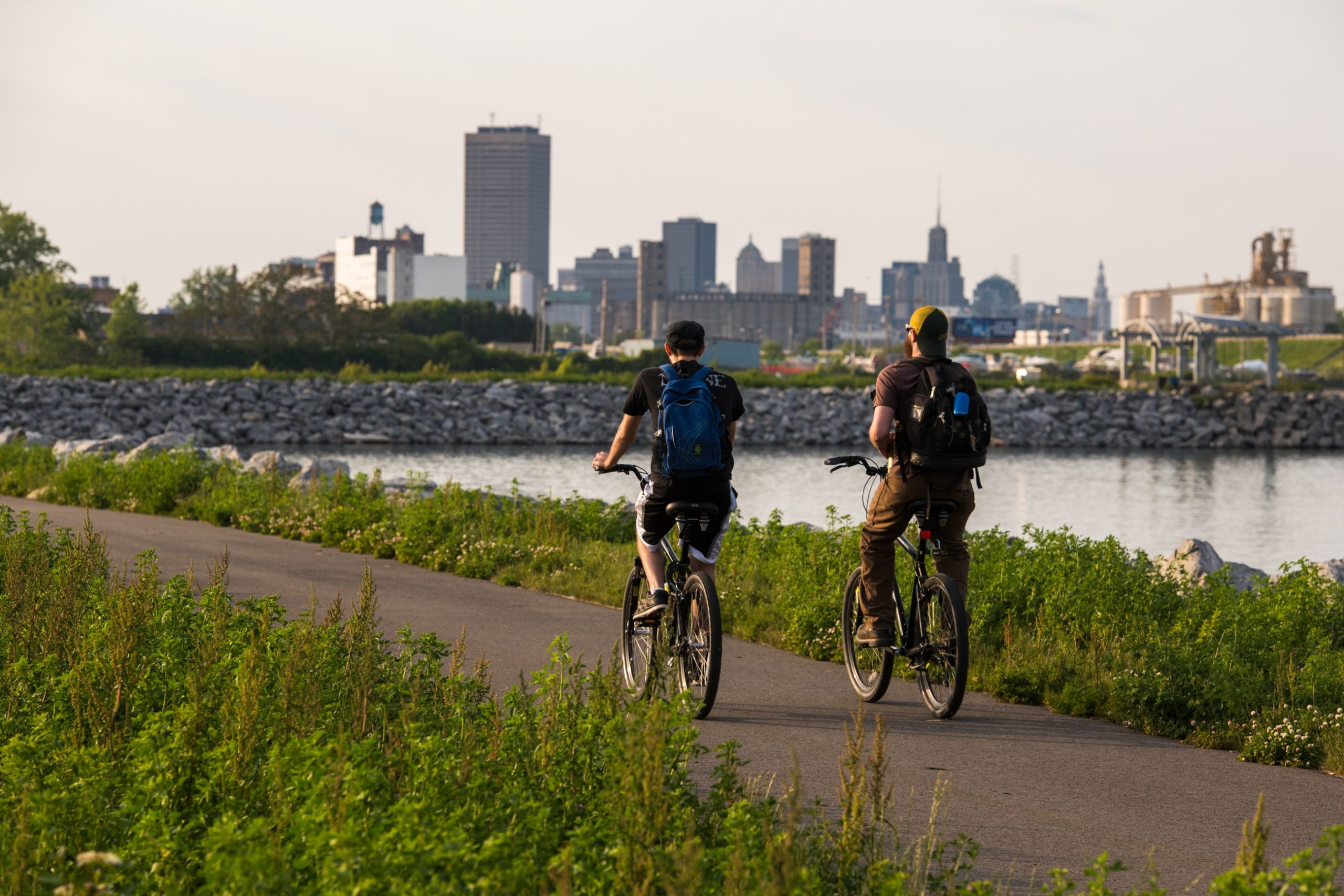 Two cyclists traveling along a waterfront trail at Buffalo Harbor State Park.