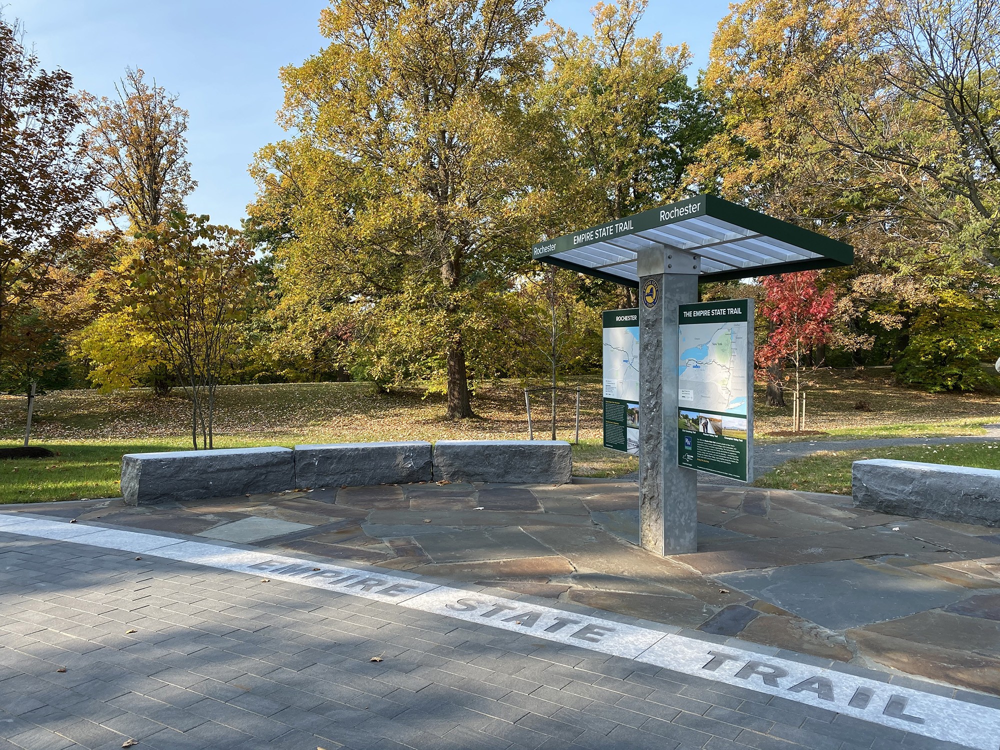 A cyclist rides past a handmade sign with a heart and the word cyclists.
